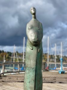 Statue of a woman holding a child at Olympia pier