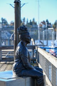 Scultpure of a woman on a steel block at Olympia pier