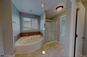 bathroom with a large white porcelain tub