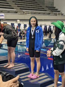 Yvy La on a podium at the Washington State Swim Championships