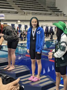 Yvy La  on a podium at the Washington State Swim Championships