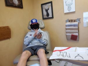 Tyler sitting in the doctor's chair at Foot & Ankle in Olympia