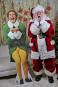 Santa Bob posing with a Buddy the Elf cutout 
