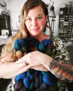 Rowan Green, of Rowan Green Fiber Arts holding some yarn