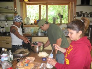 Rodocker helping prepare a meal with a guest chef