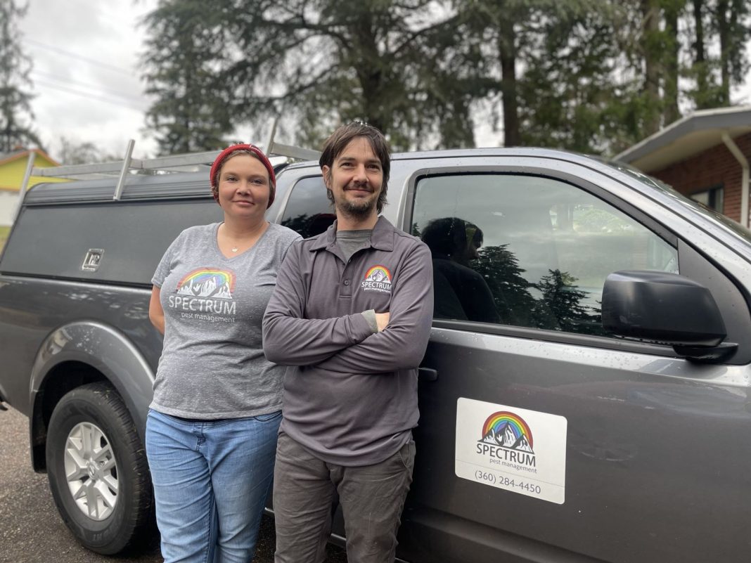 Rachel Morriss and Ronnie Lastufka of Spectrum Pest Management standing by their truck