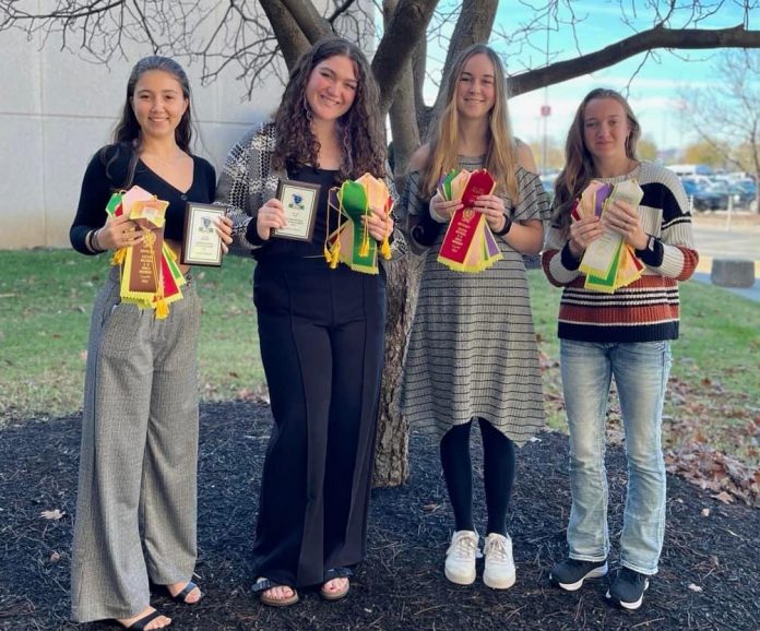 From left: Baeya Kardokus, Solana Spector, Charlotte Pestinger and Stella Harris pose with their awards from the 4-H Hippology national competition.