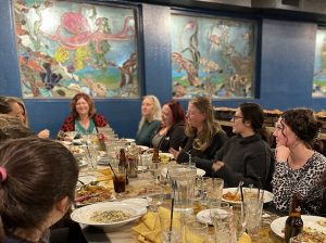 A group of women gather for a holiday party at Spirits Bar & Grill at the Old Alcohol Plant