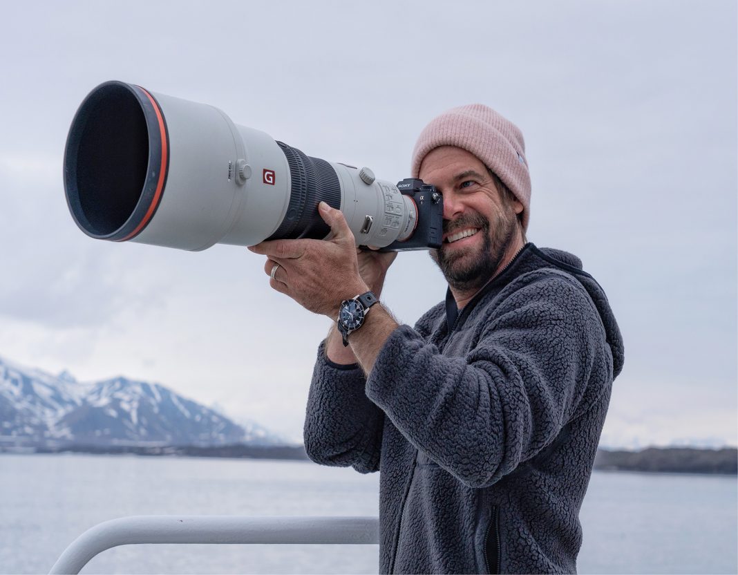 Andy Mann with a camera on a boat