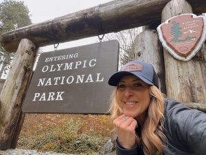 Writer Jess Caldwell  by Olympic National Park sign