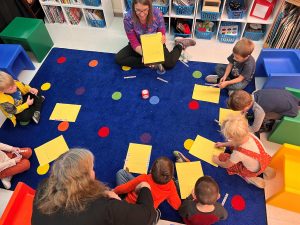 Megan Dougherty instructs her young students on the letter game they will play during circle time at the Parkside Elementary School.