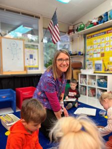 Parkside Elementary teacher Megan Dougherty on floor with students
