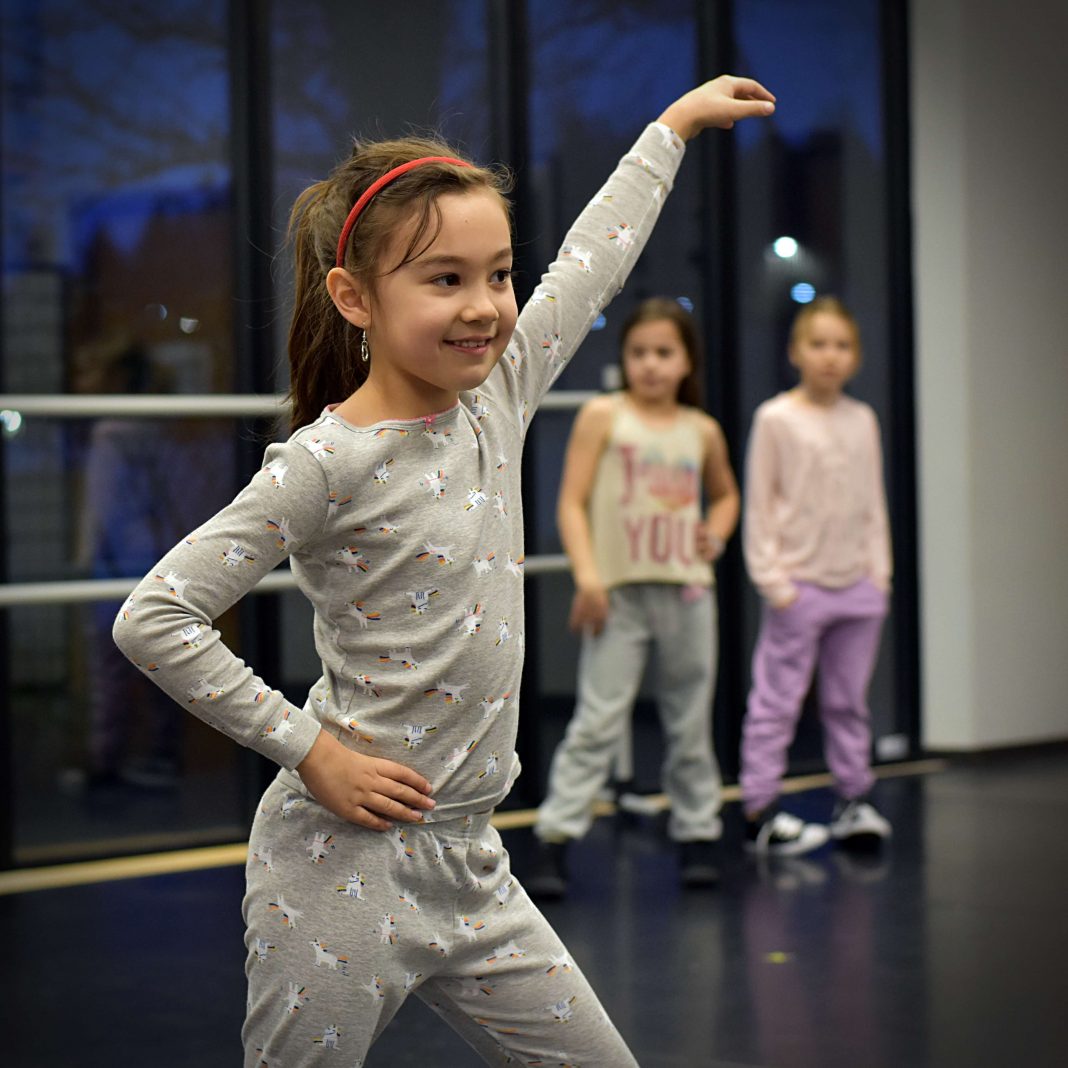 A young dancer strikes a pose with confidence after her dance routine at South Sound Studios in Tumwater.
