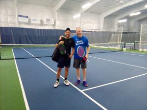 two men standing on the Tennis and Athletic Boat Club website
