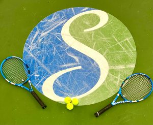 Steamboat Tennis and Athletic Club logo on a Tennis court with three tennis balls on top and two rackets lying on either side of it