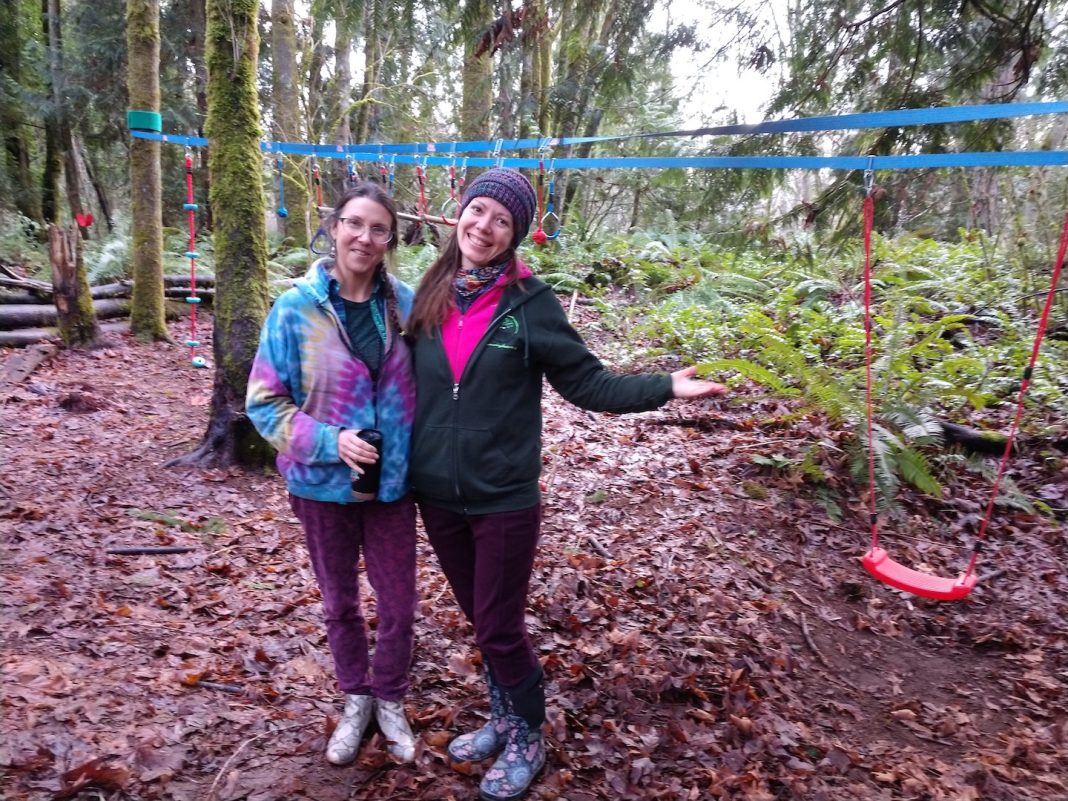 Community Nature Foundation board members Jamie Corson and Charissa Waters standing in the forest