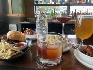 drinks, sliders and fries on a table at Cynara
