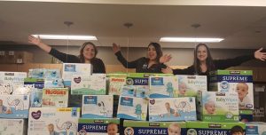 Greene Realty agents behind a tower of diaper boxes for Dry Tykes & Wet Wipes