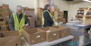 Greene Realty agents packing food boxes for the Thurston County Foodbank