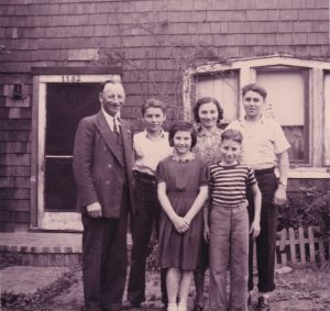 old photo of Harvey Drahos and his family outside a building