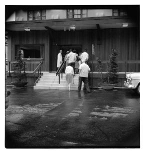 black and white photo of  visitors ascended steps to the lobby where they waited for one of the tours to start at Olympia Brewing Company