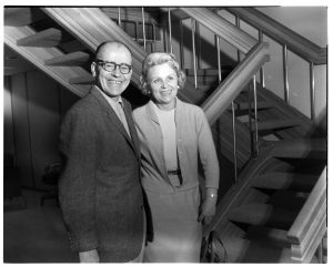 two people pose in front of the new stairs at Olympia Brewing Company in a black and white photo from the '60s