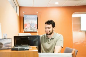 bank worker sitting at a desk with a computer at Olympia Federal Savings