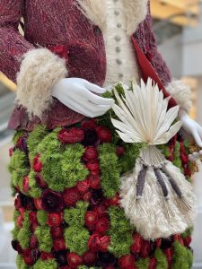 details of santa's coat, gloves and sack made of flowers