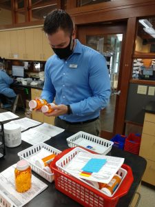 Ryan Martin fulfilling a prescription at NW Remedies