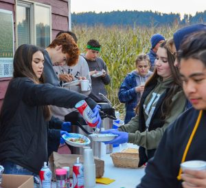 Pope John Paul II High School students volunteering at an event serving food