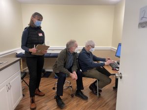 Medical Director Mike Matlock and two other people in an exam room at The Olympia Free Clinic looking at a computer