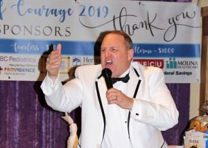Professional auctioneer, Mark Streuli, speaking into a microphone