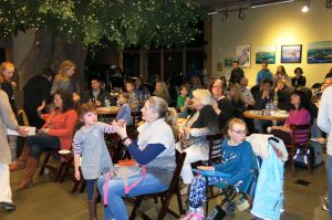 kids and parents sitting at large round tables