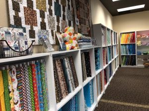 shelves of bolts of fabric at Stitches Quilt & Craft in Olympia