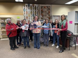 group of people cutting the ribbon