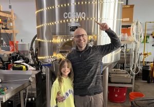 Headless Mumby owner Alex Maffeo and his daughter standing in the distillery 