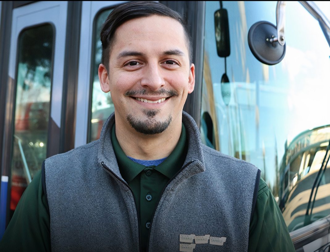 Intercity Transit bus driving smiling in front of a bus