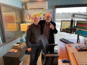 KGY DJ's Kevin Huffer and Ken Balsley standing with arms on each other's shoulders