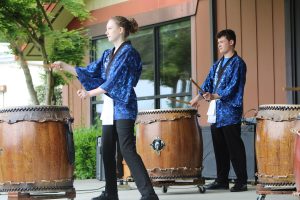 high school students performing on large Taiko drums