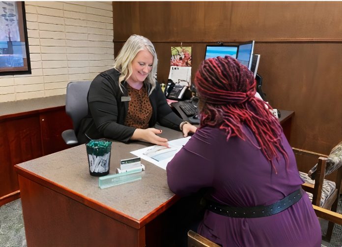 OlyFed-24-hours-Melissa-Kirkeby-appointment Melissa Kirkeby at her desk helping a customer