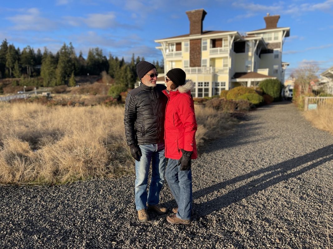 couple stand close together outside the Port Ludlow Resort