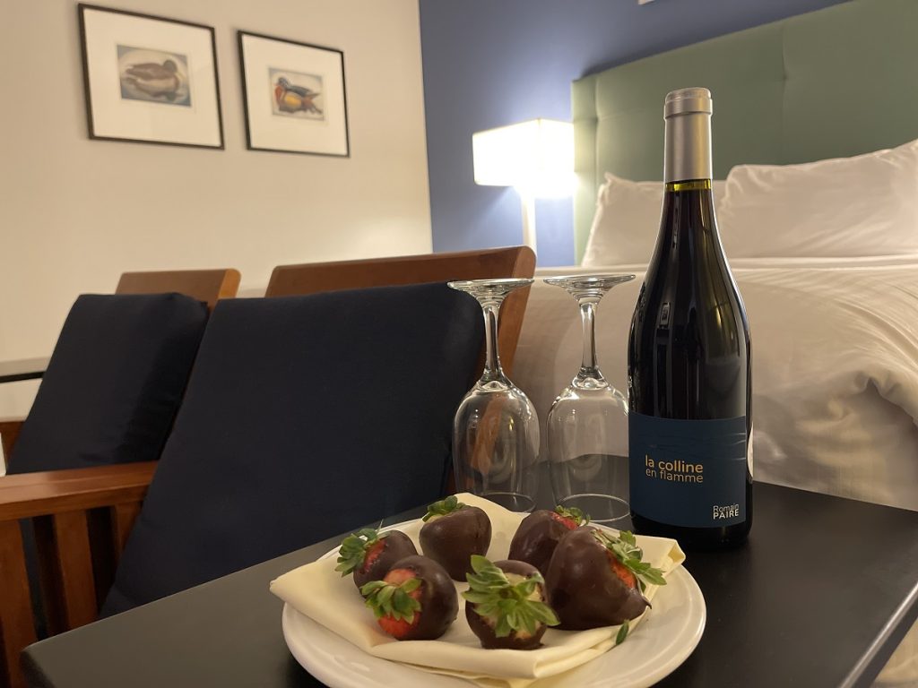 wine and chocolate-covered strawberries on a bedside table at Port Ludlow Resort