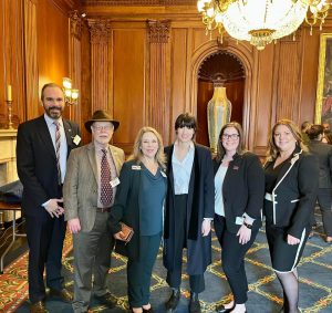 Sensory Tool House CEO Katie McMurray (right) with SBDC Director Jennifer Dye (third from left) and others supporting small businesses in a recent visit with U.S. Rep. Marie Gluesenkamp Perez (center).