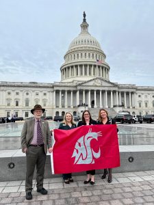 Sensory Tool House CEO Katie McMurray and three other people holding a Washington State Cougar Flag outside the White House