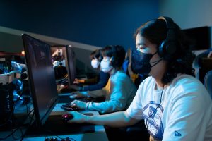 eSport students at SPSCC sitting in a room on computers with facemasks on