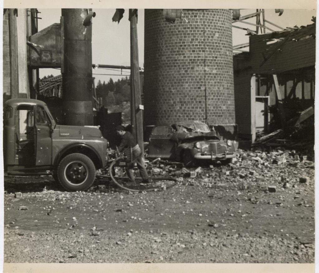 black and white photo of Washington Veneer Company’s plant in Olympia after 1949 Earthquake left damage.