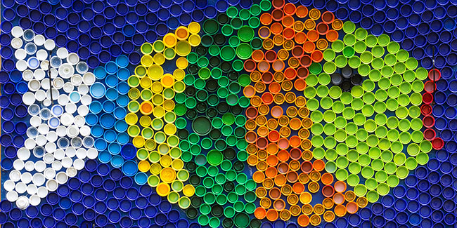 Fish mosaic deocoration made of cororful plastic bottle caps . Summer season and travel concept. Handmade crafts. Recycling art.