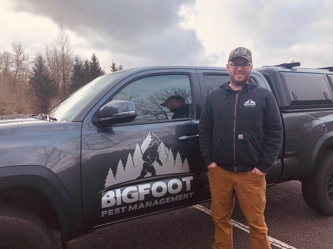 Elliott Hahn of Bigfoot Pest Management standing by his truck