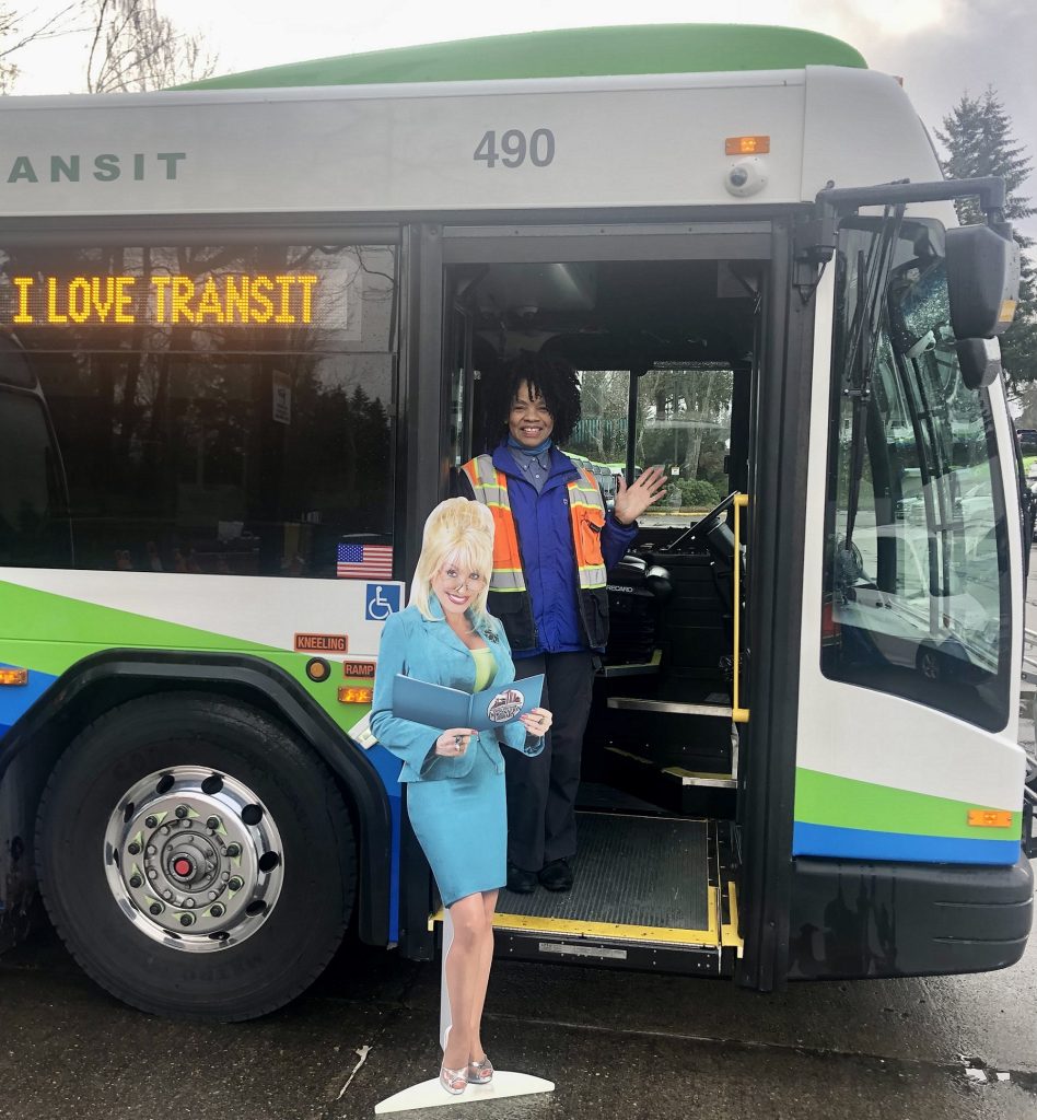 cardboard cut-out of Dolly Parton standing by an Intercity Transit bus