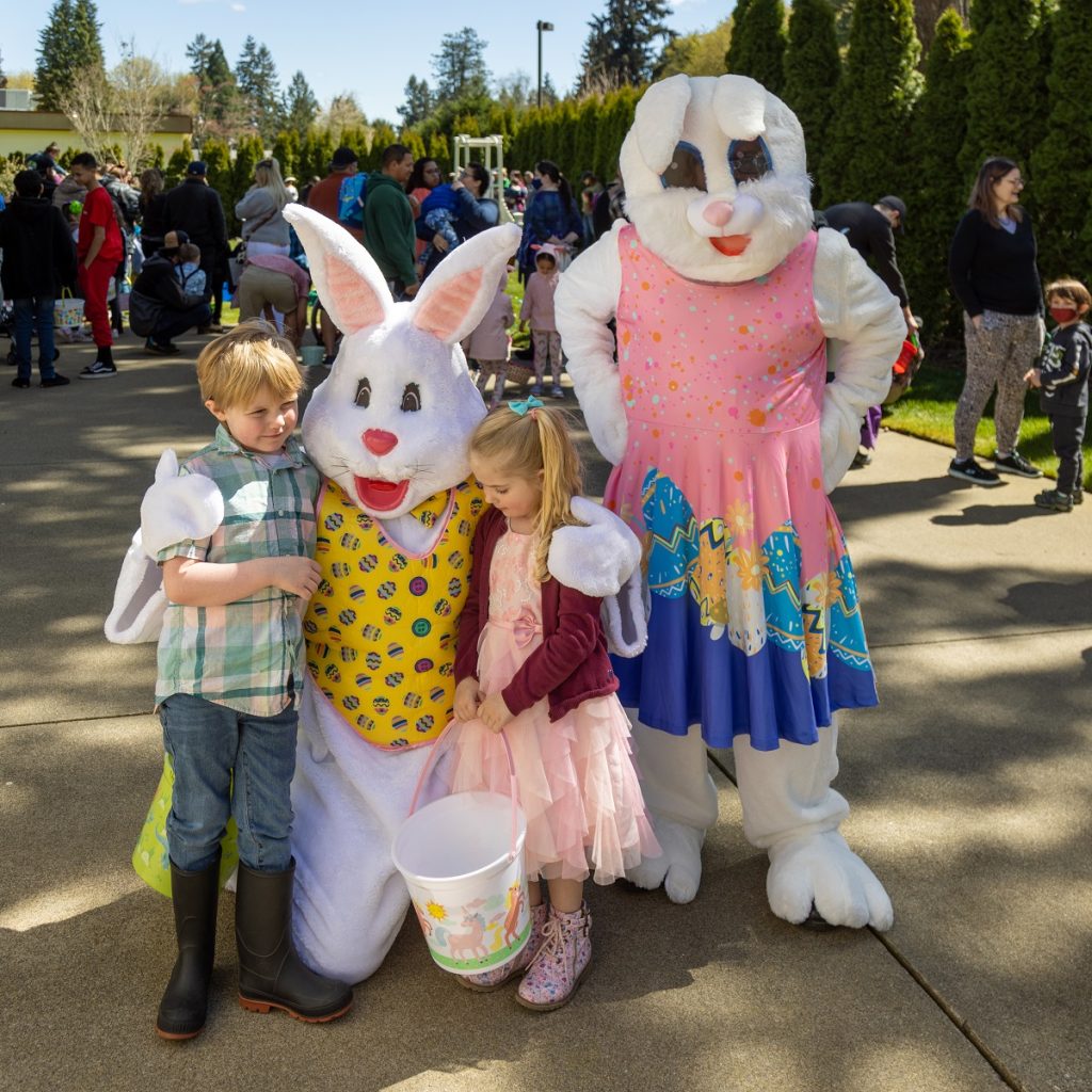 two people dressed as Easter Bunnies posing with a boy and a girl at the Olympia Lodge #1 Easter egg hunt
